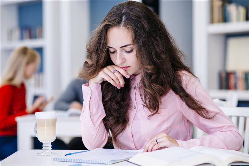 female-student-studying-library 1