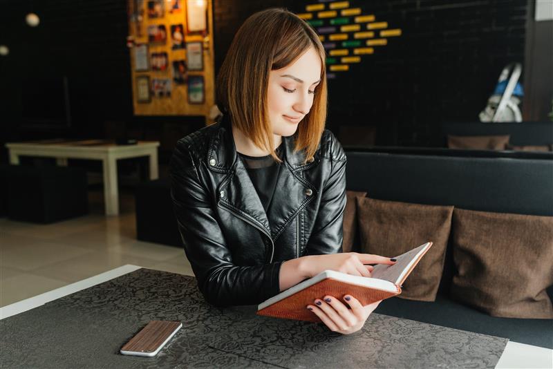 young-smiling-girl-reading-book-break-cafe